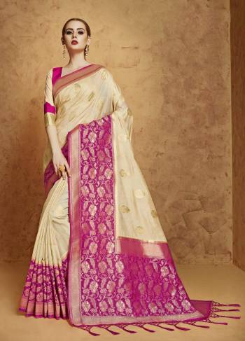 Flaunt Your Rich And Elegant Taste Wearing This Saree In Cream Color Paired With Contrasting Magenta Pink Colored Blouse. This Pretty Saree Is Fabricated On Banarasi Art Silk Paired With Banarasi Art Silk Blouse. This Saree Has Beautiful Elegant Weave All Over It Which Will Earn You Lots Of Compliments From Onlookers. 