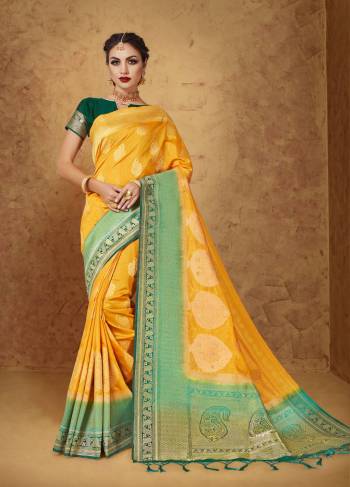 Celebrate This Festive Season Rich Banarasi Look With This Designer Saree In Yellow Color Paired With Contrasting Pine Green Colored Blouse. This Saree And Blouse Are Fabricated On Banarasi Art Silk Beautified With Weave. It IS Light Weight Which Ensures Superb Comfort Throughout The Gala.