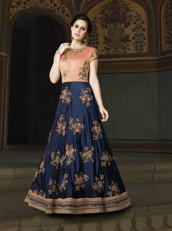 Grab This Beautiful Designer Yoke Patterned Floor Length Suit In Navy Blue And Peach Color Paired With Peach Colored Bottom And Dupatta. Its Top Is Fabricated On Art Silk Paired With Santoon Bottom And Net Dupatta. It Is Beautified With Cut Work Embroidery In Patches. Buy It Now.