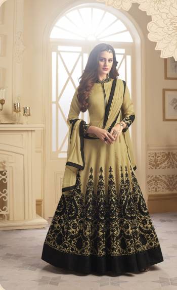 Flaunt Your Rich and Elegant Taste With This Heavy Designer Floor Length Suit In Beige Color Paired With Beige Colored Bottom And Dupatta. Its Top Is Fabricated On Satin Silk Paired With Santoon Bottom And Chiffon Dupatta. It Has Heavy Embroidery Over Its Flare And Sleeves. Buy This Readymade Suit Now.