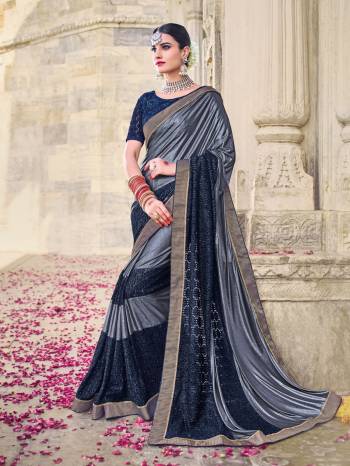 The fabulous pattern makes this saree a classy number to be included in your wardrobe. grey and navy blue color imported lycra jacquard and imported lycra sparkel saree. Ideal for party, festive & social gatherings. this gorgeous saree featuring a beautiful mix of designs. Its attractive color and beautiful design, cut paste work design work over the attire & contrast hemline adds to the look. Comes along with a contrast unstitched blouse.