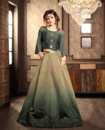 Flaunt Your Rich And Elegant Taste Wearing This Indo-Western Dress In Unique Shade Of Green With This Pine Green Colored Top Paired With Shaded Khaki And Green Colored Lehenga. Its Elegant Color And Unique Pattern Will Earn You Lots Of Compliments From Onlookers. Buy Now.