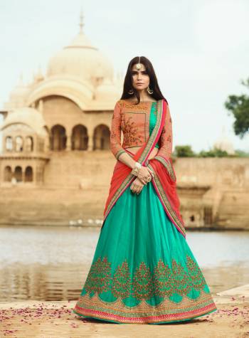 Go Colorful Wearing This Lehenga Choli In Dark Peach Colored Blouse Paired With Sea Green Colored Lehenga And Orange Colored Dupatta. This Blouse And Lehenga Are Fabricated On Art Silk Paired With Net Fabricated Dupatta. It Has Beautiful Embroidery Over the Blouse And Lehenga. It Is Light In Weight And Easy To Carry All Day Long.