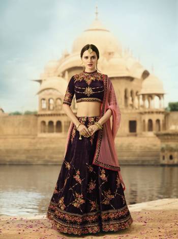 New And Unique Color Is Here Which Is Also In Very Much Demand. Grab This Attractive Lehenga Choli In Wine Color Paired With contrasting Pink Colored Dupatta. This Lehenga And Choli Are Fabricated On Velvet Paired With Net Fabricated Dupatta. This Designer Lehenga Choli Is Soft Towards Skin and easy To Carry All Day Long.