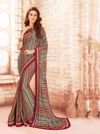 Here Is A Unique Checks Printed Saree In Multi Color Paired With Dark Grey Colored Blouse. This Saree Is Fabricated On Silk Georgette Paired With Georgette Fabricated Blouse. This Saree Is Light In Weight And Easy To Carry All Day Long. Buy This Saree Now.