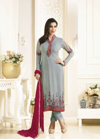 Flaunt Your Rich And Elegant Taste Wearing This Straight Cut suit In Grey Color Paired With Dark Pink Colored Dupatta. Its top Is Fabricated On Georgette Paired With Santoon Bottom And Chiffon Dupatta. It Has Embroidery Over The Neckline, Sleeves and Panel Of Suit. buy This Suit Now.