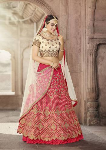 Grab This Heavy Lehenga Choli For The Next Wedding With This Cream Colored Blouse Paired With Pink Colored Lehenga And Cream Colored Dupatta. This Lehenga Choli Is Fabricated On Art Silk Paired With Net Fabricated Blouse. It Has Beautifiul Heavy Embroidery Over It, Buy This Designer Lehenga Choli Now.