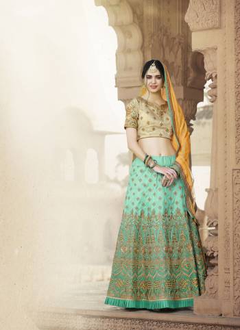 Unique And Attractive Combination Is Here With This Designer Lehenga Choli In Beige Colored Blouse Paired With Aqua Blue Colored Lehenga And Contrasting Musturd Yellow Colored Dupatta. Its Lehenga And Choli Are fabricated On Art Silk Paired With Chiffon Dupatta. 