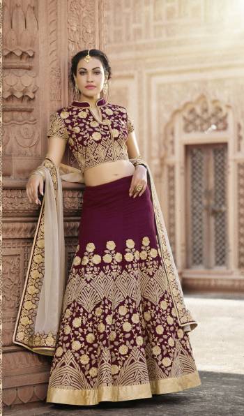 Add this Lovely Color To Your Wardrobe With This Lehenga Choli In Wine Color Paired With Contrasting Pale Grey Colored Dupatta. This Lehenga Choli Is Fabricated On Art Silk Paired With Chiffon Dupatta. It Is Beautified With Heavy Embroidery All Over, This Designer Lehenga Choli Will Definitely Earn You Lots Of Compliments From Onlookers.