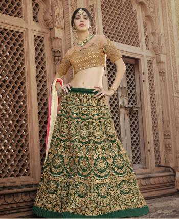 If You Are Lady With Trend Than Grab This Designer Lehenga Choli In Beige Colored Blouse Paired With Green Colored Lehenga And Pink And Cream Dupatta. Its Blouse Is Fabricated On Art Silk and Net Paired With Art Silk Lehenga And Chiffon Dupatta. This Lehenga Choli Is Light Weight And Easy To Carry Throughout The Gala.