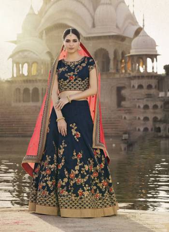 Get Ready For This Wedding Season With This Designer Lehenga Choli In Navy Blue Color Paired With Contrasting Orange Colored Dupatta. This Lehenga Choli Is Fabricated On Art Silk Paired With Chiffon Dupatta.It Has Detailed Embroidery Which Is Making The Lehenga Choli More Attractive.