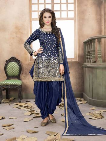 For An Elagtn Beauty Grab This Salwar Suit In Navy Blue Color Paired With Navy Blue Colored Bottom And Dupatta. Its Top Is Fabricated On Art Silk Paired With Santoon Bottom And Net Dupatta. It Is Beautified With Mirror Work All Over It. Buy Now.