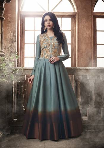 Shades Are In This Season And Thus We Are Here With This Lovwly Designer Shaded Floor Length Suit In Steel Blue And Brown Color Paired With Brown Colored Bottom And Dupatta. Its Top Is Fabricated On Tussar Art Silk Paired With Santoon Bottom And Chiffon Dupatta. 