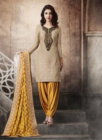 Rich And Trendy Look Is Here With This Salwar Suit In Beige Colored Top Paired With Musturd Yellow Colored Bottom And Dupatta. Its top Is Fabricated On Khadi Silk Paired With Jersey Fabric Bottom And Jacquard Silk Dupatta. This Rich And Trendy Suit Will Definitely Earn you Lots Of Compliments From Onlookers.