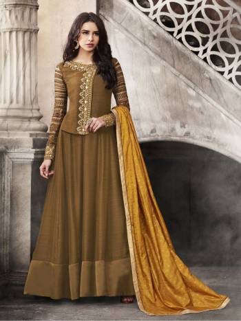 Beautiful Shade Is Green Is Here With This Designer Floor Length Suit In Olive Green Color Paired With Olive Green Colored Bottom And Contrasting Musturd Yellow Colored Dupatta. Its Top Is Fabricated On Satin Paired With Santoon Bottom And Jacquard Silk Dupatta. This Lovely Suit Is Light Weight And Easy To Carry All Day Long.