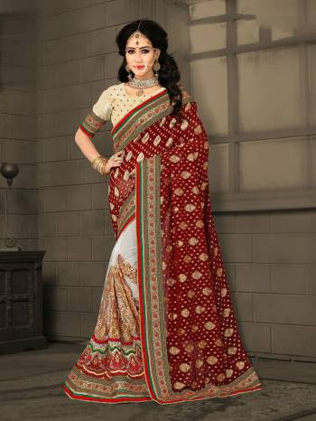 Adorn The Beautiful Queen Look Wearing This Saree In Maroon And White Color Paired With Cream Colored Blouse. This Saree Is Fabricated On Jacquard Georgette Paired With Gota Fabricated Blouse. It Is Durable And easy To Carry For.