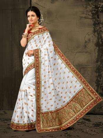 Simple And Ellgant Looking Saree IS Here With This Saree In White Color Paired With Red Colored Blouse. This Saree And Blouse Are Fabricated On Art Silk Which Is Durable and Easy To Drape. Buy This Pretty Elegant Saree Now.