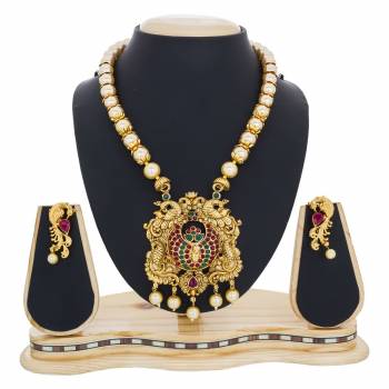 Grab This Beautiful Designer Necklace Set In Golden Color Which Has Chain Of Pearls And Also It Is Beautified With Green And Pink Colored Stones. Buy This Now.