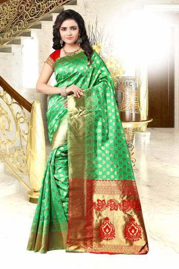 For A Proper Taditonal Look, Grab This Banarasi Saree In Green Color Paired With Contrasting Red Colored Blouse. This Saree And Blouse Are Fabricated On Banarasi Art Silk Beautified With Weave All Over It. 