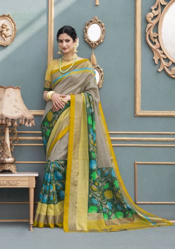 Add This Pretty Saree To Your Wardrobe In Grey And Green Color Paired With Pear Green Colored Blouse. This Saree And Blouse Are Fabricated On Tussar Art Silk Beautified With Bold Floral Prints.