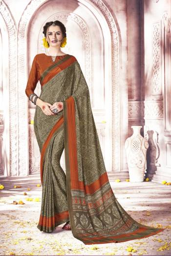 New And Unique Shade Of Green Is Here With This Saree In Light Olive Green Color Paired With Contrasting Rust Orange Colored Blouse. This Saree And Blouse Are Fabricated On Crepe Silk Which Is Soft Towards Skin And Easy To Carry All Day Long.