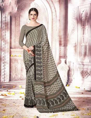 Rich And Elegant Looking Saree Is Here With This Saree In Grey Color Paired With Grey Colored Blouse. It Has Pretty Small Paisly Prints All Over The Saree And Blouse. It Is Easy To Drape And Also Easy To Care For.