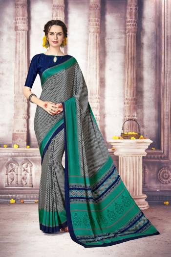 Enhance Your Personality Wearing this Elegant Looking Saree In Grey Color Paired With Royal Blue Colored Blouse. This Saree And Blouse Are Fabricated On Crepe Silk Beautified With Intricate Prints. It Is Light Weight And Easy To Carry In Your Daily Wear Or To Wear At Your Work Place.