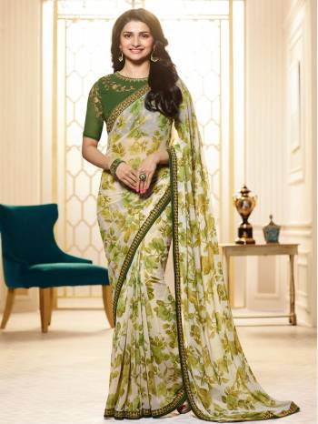 Celebrate This Festive Season Wearing This Designer Saree In In White And Green Color Paired With Dark Green Colored Blouse. This Saree Is Fabricated On Georgette Beautified with Bold Prints Paired With Art Silk Fabricated Embroidered Blouse. Buy This Designer Saree Now.