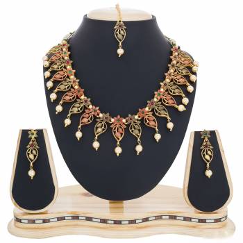 Elegant Looking Pattern Is Here In This Necklace Set In Golden Color Beautified With Multi Colored Stones. You Can Pair This Set With Contrasting Colored Traditional Attire. Buy Now.