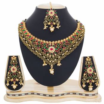 This Wedding Season Catch All The Lime Light Wearing This Heavy Necklace Set In Golden Color Beautified With Multi Colored Stones. This Necklace set Is Made Of Mix Metal Which Is Easy To carry Throughout The Gala. 