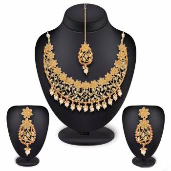 New And Unique Designer Necklace Set Is Here. Grab This Beautiful Set In Golden Color Which Is Beautified With White Colored Stones And Pearls. This Pretty Piece Can Be Paired With Any Colored Traditonal Attire. Buy Now.