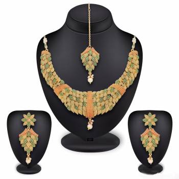 Elegant Looking Pattern Is Here In This Necklace Set In Golden Color Beautified With Green Color Highlight. You Can Pair This Set With Contrasting Colored Traditional Attire. Buy Now.