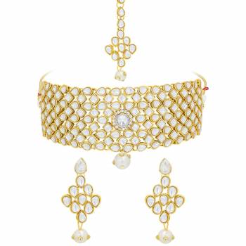 Here Is A Designer Choker Necklace Set In Golden Color Beautified with Kundan Work. Its Bright White And Golden Color Will Make You Look The Most Attractive Of all. You Can Pair This Up With Any Colored Traditional Attire. Buy Now.