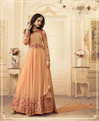 Most Demanding Color Of The Season Is Here With This Pretty Peach Colored Designer Floor Length Paired With Peach Colored Bottom And Dupatta. Its Pretty Heavy Embroidered Top Is Fabricated On Georgette Paired With Santoon Bottom And Chiffon Dupatta. Its All Three Fabrics Ensures Superb Comfort All Day Long. Buy It Now.