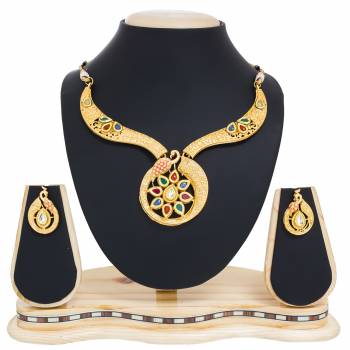 Give An Elegant Look To Your Neckline Wearing This Rich Looking Necklace Set In Golden Color Beautified With Multi Colored Stone Work. This Necklace Set Can Be Paired With Any Colored Traditonal Attire.