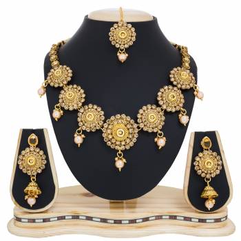 This Wedding Season Give Your Attire More Heavy And Elegant Look Pairing It With This Attractive Heavy Necklace Set In Golden Color Beautified with White Colored Stones. This Can Be Paired With Any Colored Traditional Attire. Buy Now.