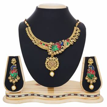 Here Is Peacock Patterned Necklace Set In Golden Color Beautified With Multi Colors And Stones Work. This Necklace Set Is Light Weight And Easy To Carry Throughout The Gala. Buy Now.