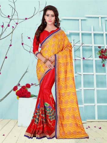 Adorn The Proper Traditional Look Wearing This Saree In Red And Yellow Color Paired With Red Colored Blouse. This Saree Is Fabricated On Georgette And Art Silk Paired With Art Silk Fabricated Blouse. It Has Beautiful Peacock Embroidery Over Its Panel Making The Saree Attractive.