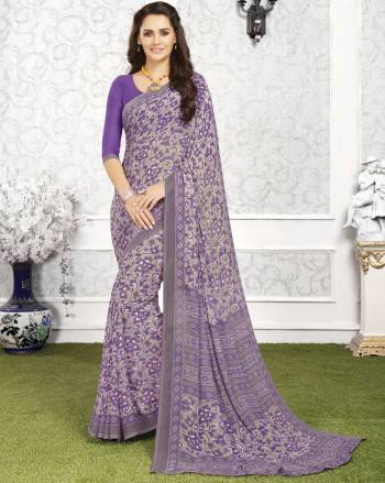 Add This Casual Saree To Your Wardrobe In Grey And Purple Color Paired With Purple Colored Blouse. This Saree And Blouse Are Fabricated On Georgette Beauified With Floral Prints All Over It. 