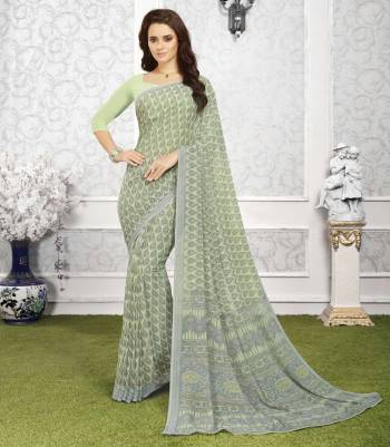 This seaosn Is About Subtle Shades And Pastel Play, So Grab This Saree In Pastel Green Color Paired With Pastel Green Colored Blouse. This Saree And Blouse Are Fabricated On Georgette Beautified With Light Prints All Over. Buy This Saree Now.