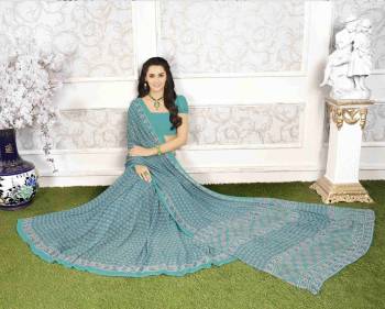 Go With This Pretty Shade Of Blue With This Saree In Tuquoise Blue Color Paired With Tuquoise Blue Colored Blouse. This Pretty Saree And Blouse Are Fabricated On Georgette Beautified With Simple Prints All Over It. Buy This Saree Now.