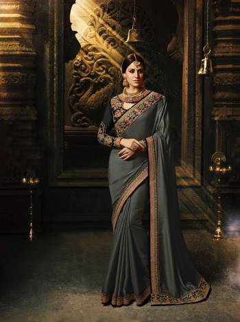 Enhance Your Personality Wearing This Saree In Dark Grey Color Paired With Black Colored Blouse. This Saree Is Fabricated On Soft Silk Paired With Art Silk And Georgette Fabricated Blouse. It Has Multi Colored Embroidery Over The Blouse And Lace Border. Buy This Saree Now.