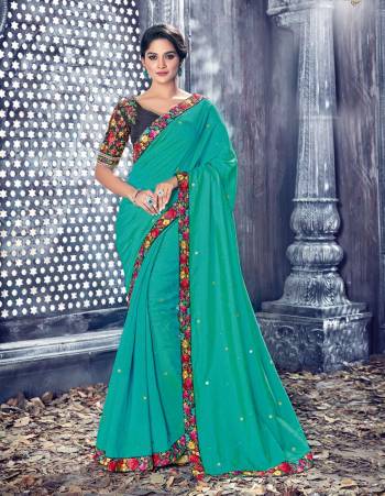 Cool Color Pallete Is Here With This Saree In Sea Green Color Paired With Contrasting Navy Blue Colored Blouse. This Saree And Blouse Are Fabricated On Art Silk Beautified With Multi Colored Thread Embroidered Lace Border And Blouse. Buy This Saree Now.