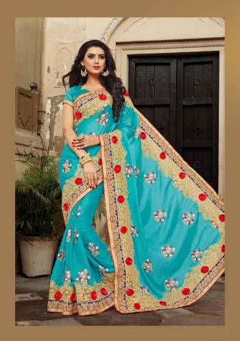 Add This Lovely Saree To Your Wardrobe In Turquoise Blue Color Paired With Turquoise Blue Colored Blouse. This Saree Is Fabricated On Georgette Paired With Art Silk Fabricated Blouse. It Has Attractive Embroidery All Over With Red Colored 3D Flowers.