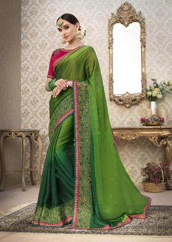 Here Is A Very Rich Looking Saree In Green Color Paired With Contrasting Dark Pink Colored Blouse. This Saree Is Fabricated On Chiffon Paired With Art Silk Fabricated Blouse. Its Detailed Embroidery Over The Border And Blouse Is Making The Saree Attractive. Buy This Saree Now.