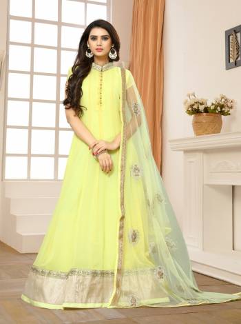 Look Pretty Wearing This Designer Floor Length Suit In Light Yellow Color Paired With Light Yellow Colored Bottom And Dupatta. Its Top Is Fabricated On Georgette Paired With Santoon Bottom And Net Dupatta. This Suit Will Earn You Lots Of Compliments From Onlookers.  