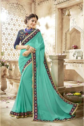 Go With The Shades Of Blue Wearing This Saree In Aqua Blue Color Paired With Navy Blue Colored Blouse. This Saree Is Fabricated On Georgette Paired With Art Silk Fabricated Blouse. This Pretty Saree Is Light In Weight And Easy To Carry All Day Long.