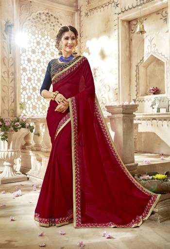 Attract All Wearing This Saree In Dark Red Color Paired With Contrasting Navy Blue Colored Blouse. This Saree Is Fabricated On Georgette Paired With Art Silk Fabricated Blouse. This Saree Will Earn You Lots Of Compliments From Onlookers.