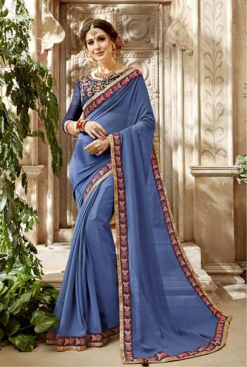 New Shade In Blue Is Here With This Steel Blue Colored Saree Paired With Steel Blue Colored Blouse. This Saree Is Fabricated On Georgette Paired With Art Silk Fabricated Blouse, Beautified With Multi Colored Embroidery. Buy This Saree Now.