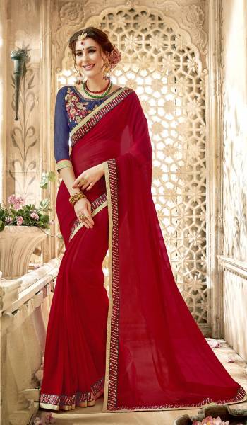 Adorn The Angelic Look Wearing This Saree In Red Color Paired With Contrasting Navy Blue Colored Blouse. This Saree Is Fabricated On Georgette Paired With Art Silk Fabricated Blouse. This Saree Is Light In Weight And Easy To Carry All Day Long. Buy Now.